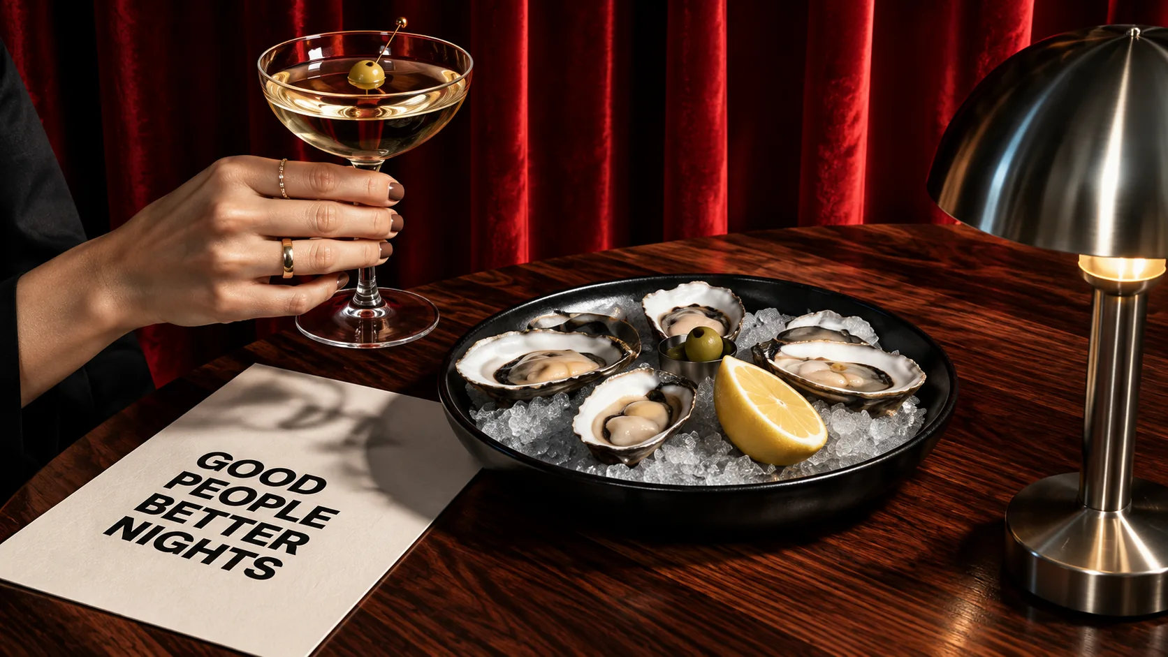 Sunday Social restaurant table with oysters on ice, a martini and a Good People Better Nights card